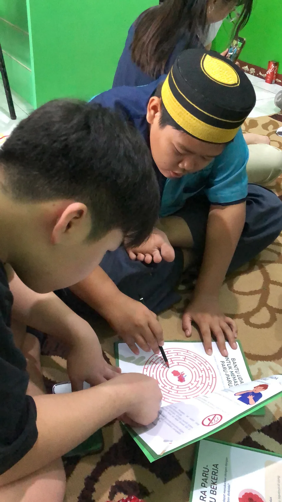 A volunteer helping a learner with an illustrated workbook.