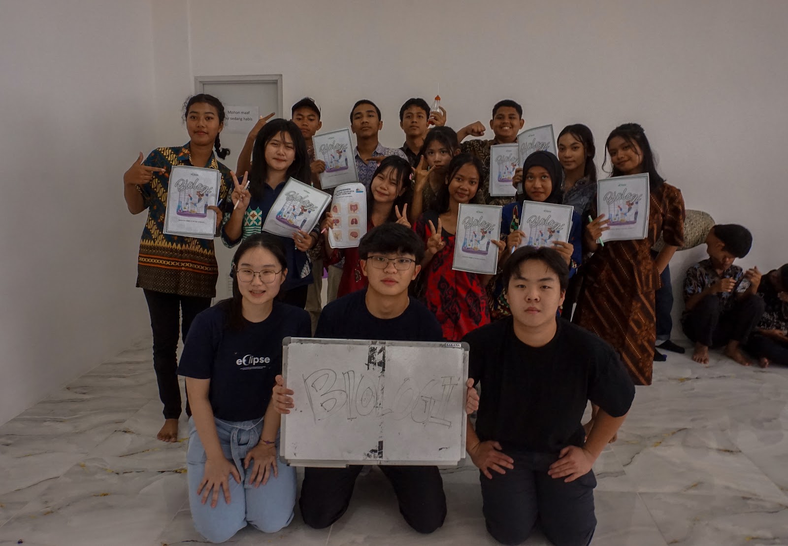 Volunteers and participants displaying their learning materials
