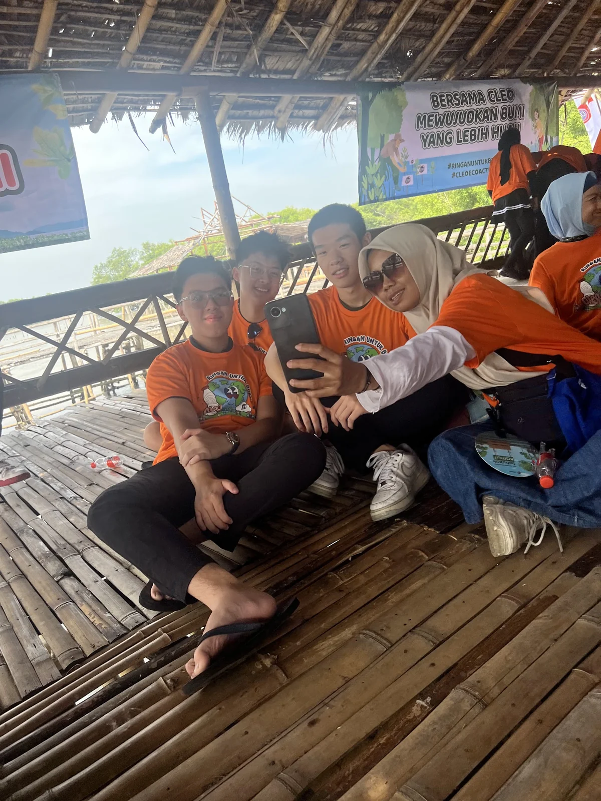 Participants sharing a moment on the wooden deck at the mangrove event
